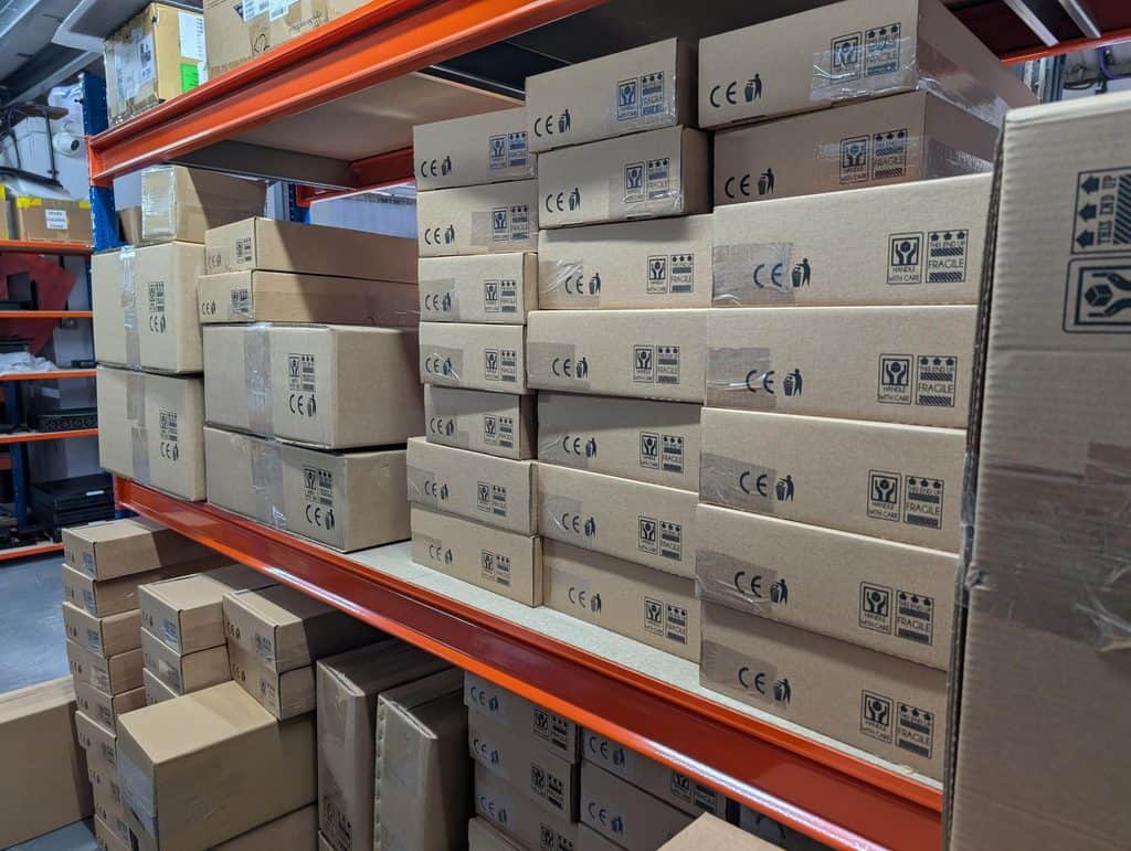 A shelf of boxed 1U Nanos, 1U NUCs and 1U PC builds ready for shipping.