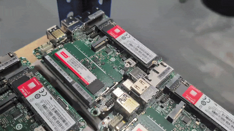 Twenty or more 1U NUC built-up motherboards ready for housing.